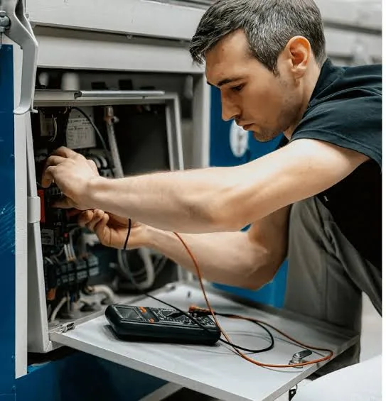 Technician using a meter to diagnose electrical HVAC components